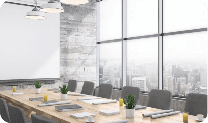 Boardroom table beside a floor-to-ceiling window wall overlooking a city