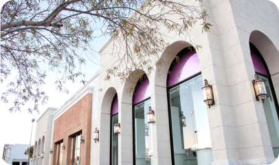 Row of tall arched display windows along a retail building