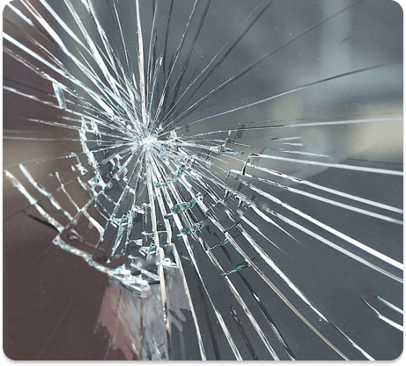 Shattered pane of glass held together in a spider-web crack pattern