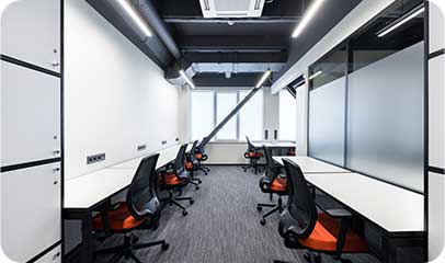 Office workstations separated by frosted glass partitions